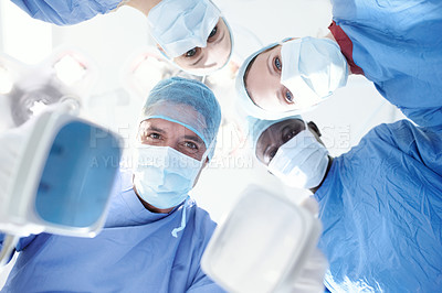 Buy stock photo Patient's view of medical staff using a difibulator attempting to revive and resuscitate