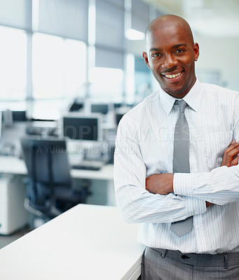 Buy stock photo Copyspace alongside an african american businessman smiling while standing with arms crossed in an office. One ambitious leader and confident entrepreneur ready for success in his corporate company