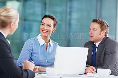 Buy stock photo Three business associates working together during a meeting