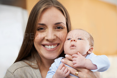 Buy stock photo Closeup portrait of happy mom holding adorable newborn baby boy at home. Face of cheerful woman on maternity leave excited for motherhood with cute infant. Smiling parent bonding with little child
