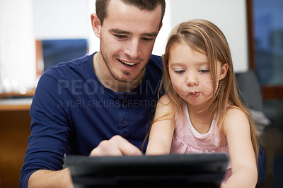 Buy stock photo A father and daughter bonding over technology