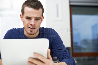 Buy stock photo Home, man and scroll with tablet for reading, local news and entertainment on social media in kitchen. House, curious person and digital with subscription for online games, ebook or streaming service