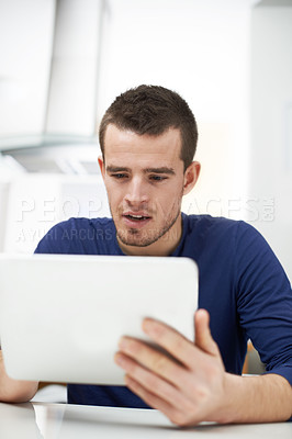 Buy stock photo Home, man and website with tablet for reading, local news and connection for social media in kitchen. House, curious person and digital with subscription for online games, ebook and streaming service
