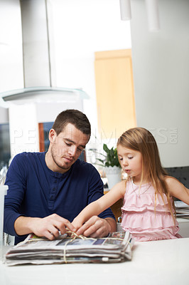 Buy stock photo Man, kid and paper in home for recycling, environment care and teach social responsibility. Father, young girl and newspaper in living room for go green, eco drive and child learning waste reduction