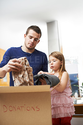 Buy stock photo Parent, child and box with clothes for donation, promote sustainability and support for charity. Home, father and girl with cardboard for nonprofit organization, community and package for giveaway