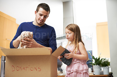 Buy stock photo Father, child and clothes in box for donation activity of charity, community service and volunteer project. Family, man and girl with cardboard for giving process, helping others and bonding at house