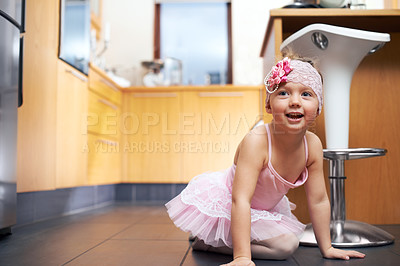Buy stock photo Little girl, child and ballerina with pink dress in kitchen for playful weekend, dance or fashion at home. Kid, toddler or young artist with costume, dream or vision for princess imagination at house
