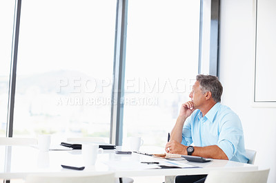 Buy stock photo A mature advertising executive looking thoughtfully out of the window of the boardroom