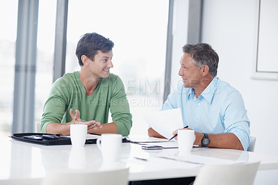 Buy stock photo A young advertising executive pitching and idea to his boss