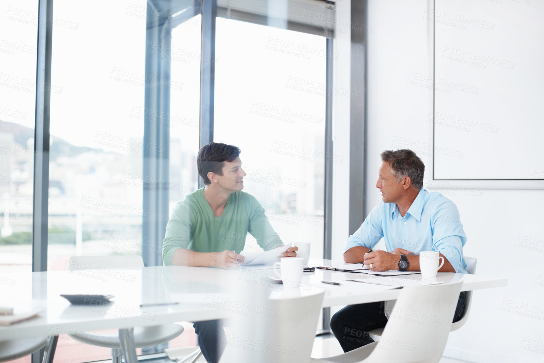 Buy stock photo A young advertising executive pitching an idea to his boss