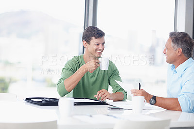 Buy stock photo A young office worker discussing ideas with his boss