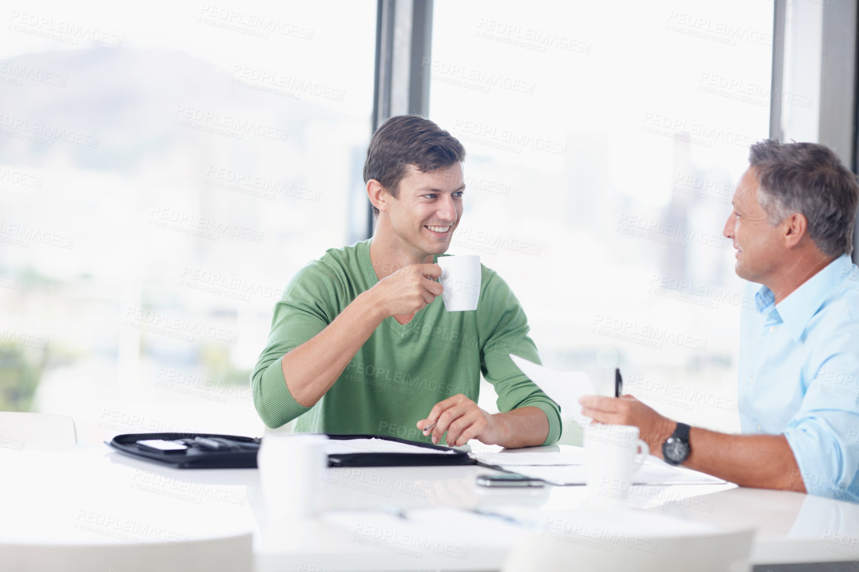 Buy stock photo A young office worker discussing ideas with his boss