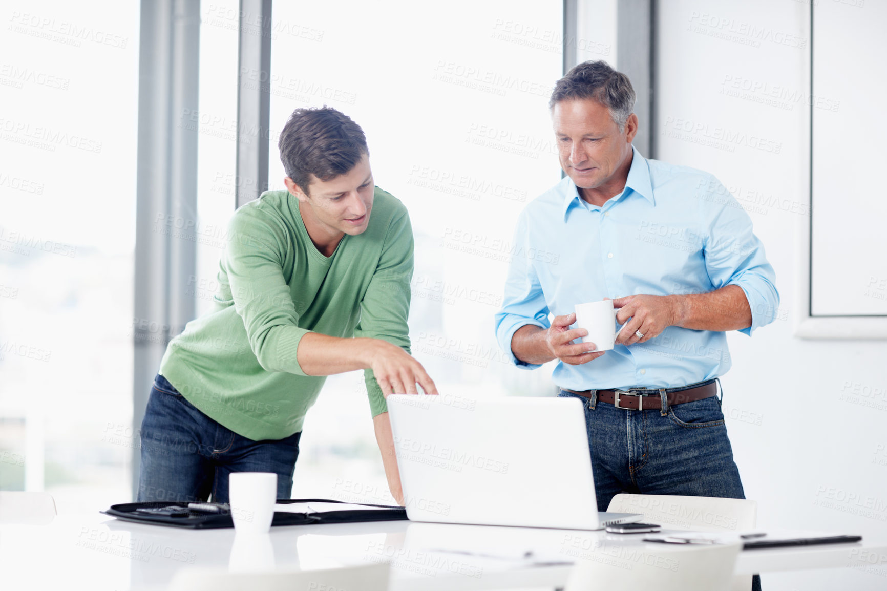 Buy stock photo A mature advertising executive working with a younger colleague