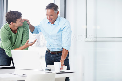 Buy stock photo A mature advertising executive working with a younger colleague