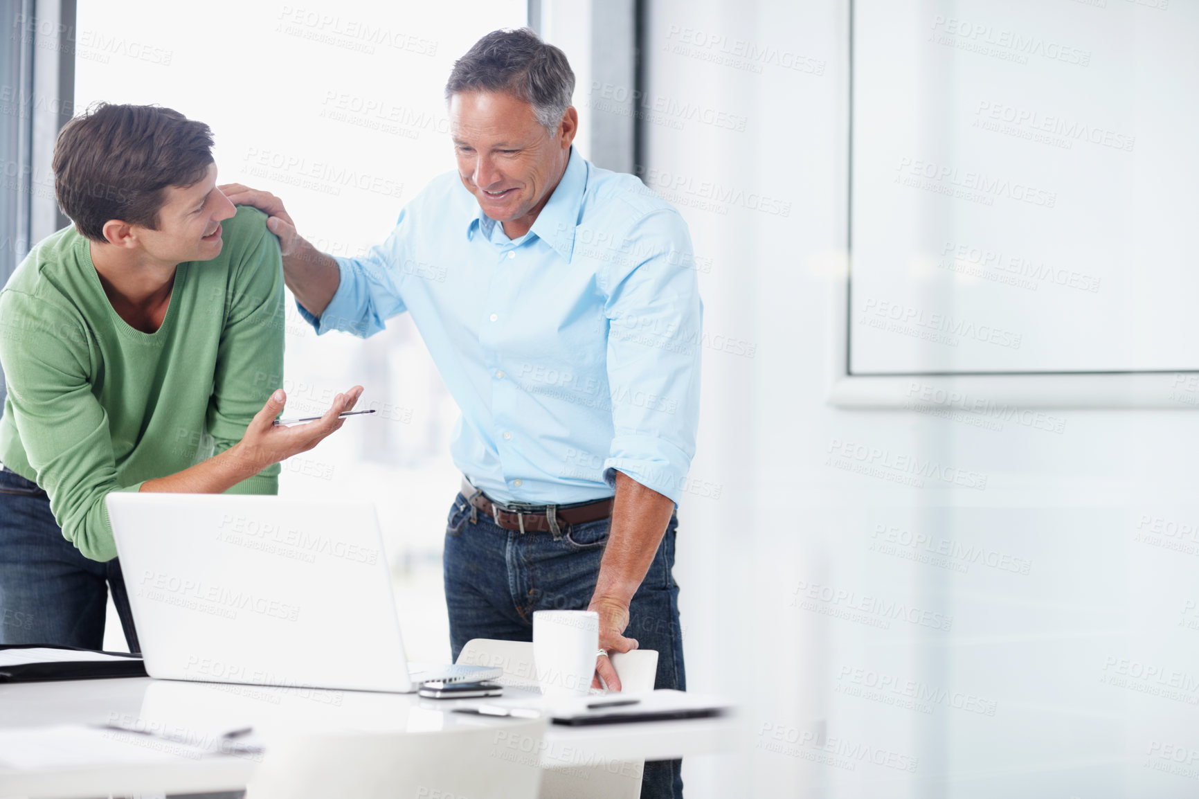 Buy stock photo A mature advertising executive working with a younger colleague
