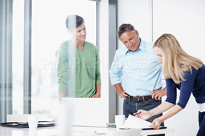 Buy stock photo Three advertising executives going over their next pitch