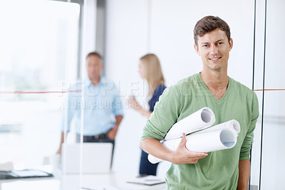 Buy stock photo Portrait of a young architect holding his blueprints