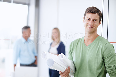 Buy stock photo Portrait of a young architect holding his blueprints