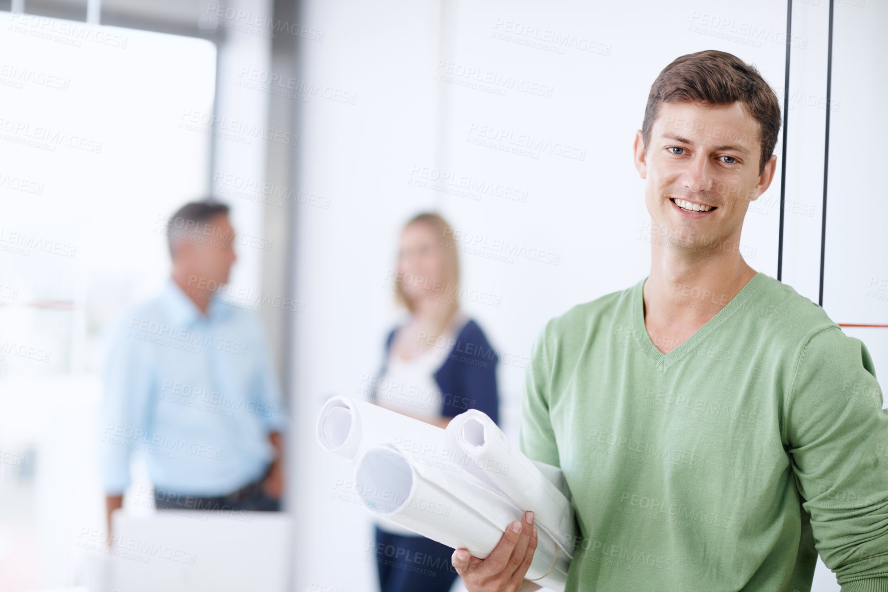 Buy stock photo Portrait of a young architect holding his blueprints