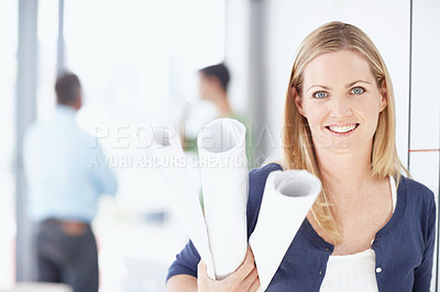 Buy stock photo Portrait of a young architect holding her blueprints in her hand