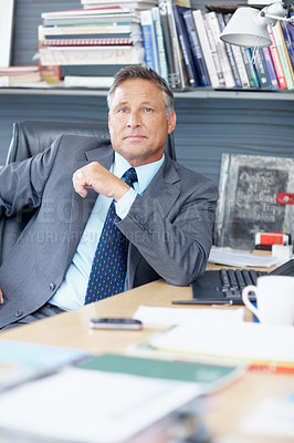Buy stock photo Portrait of an experienced business manager sitting at his desk