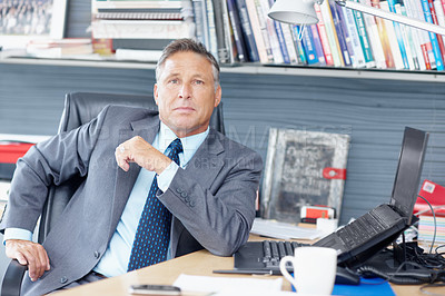 Buy stock photo Portrait of a formidable business manager sitting at his desk - Copyspace