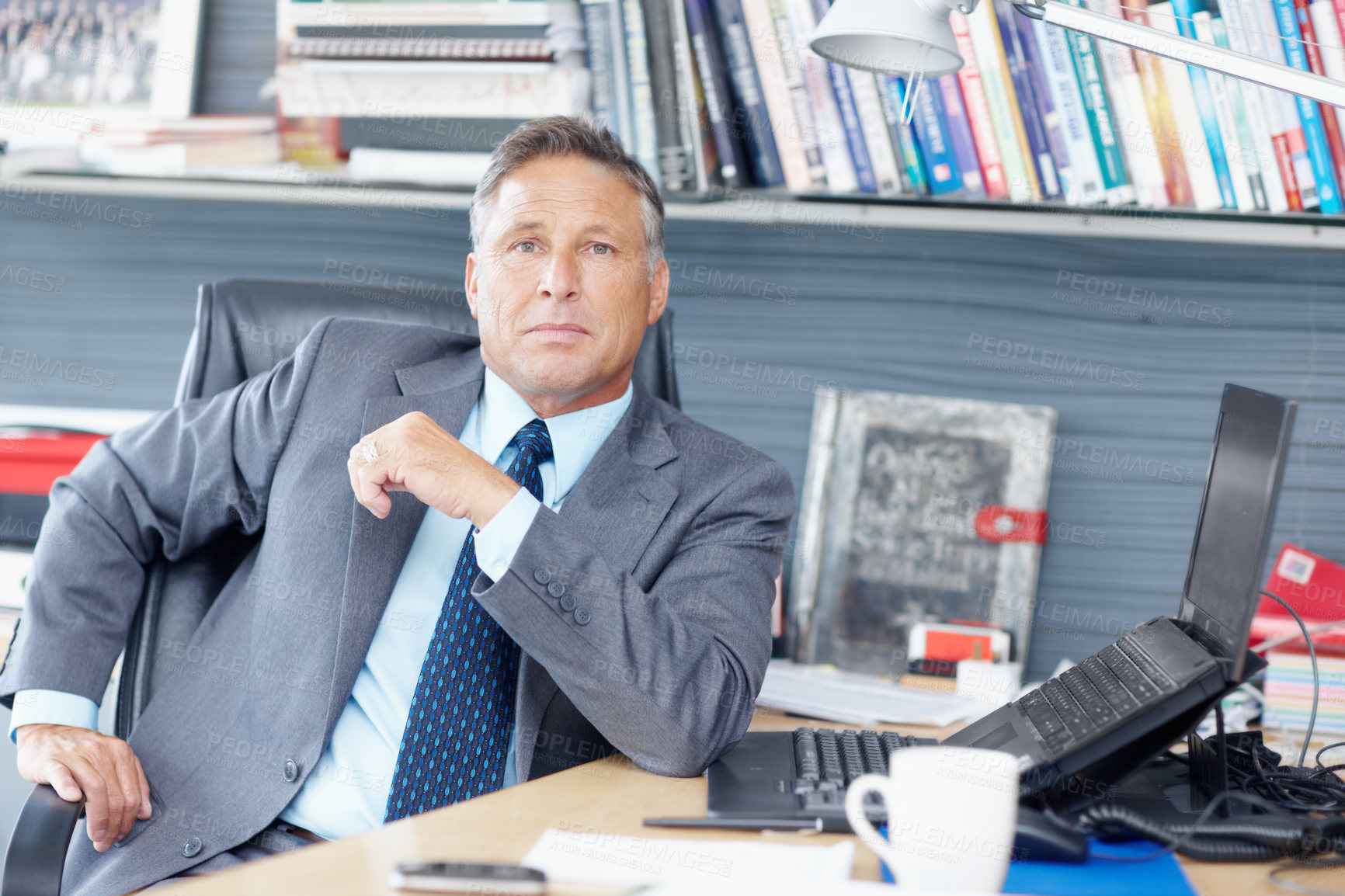 Buy stock photo Portrait of a formidable business manager sitting at his desk - Copyspace