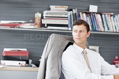 Buy stock photo A young executive looking out of his window thoughtfully - Copyspace