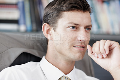 Buy stock photo A talented young businessman realising he is approaching a solution to his problem