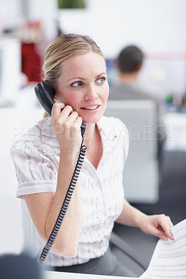 Buy stock photo A lively businesswoman taking an important phonecall at her desk