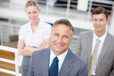 Buy stock photo Top-view portrait of an experienced executive with his colleagues standing behind him