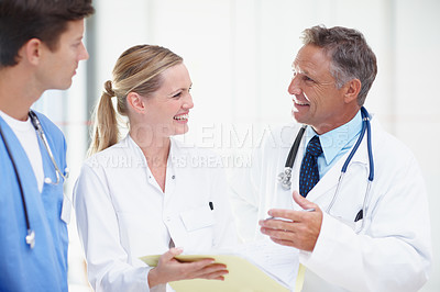 Buy stock photo Three medical professionals sharing advice and ideas