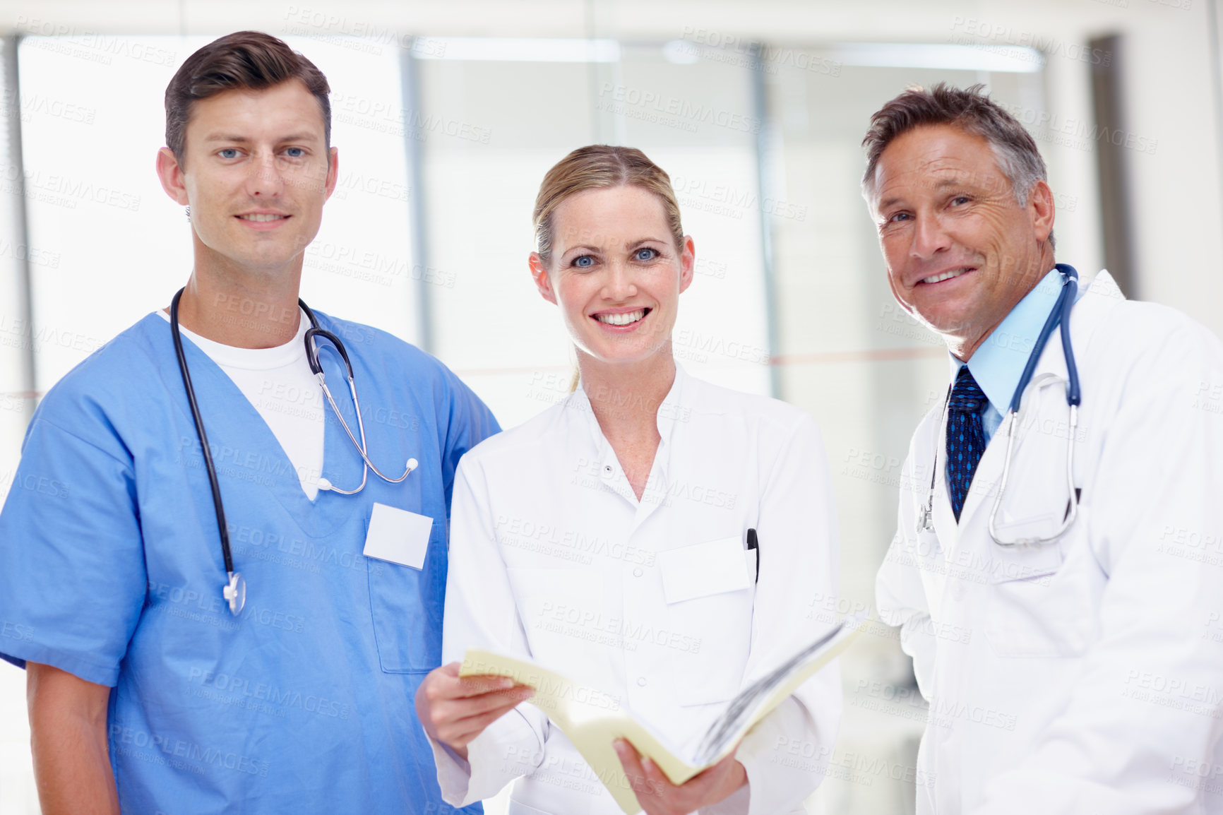 Buy stock photo Portrait of three medical professionals standing together and smiling