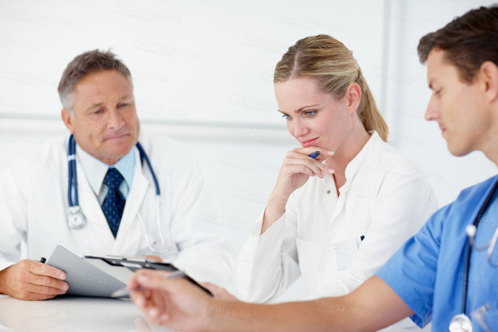 Buy stock photo Three medical professionals having a catch up meeting together