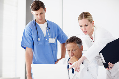 Buy stock photo Group, laptop and concerned with doctors for healthcare results, online feedback or report discussion. Hospital staff, man and woman for bad news, discovery and collaboration for surgery research