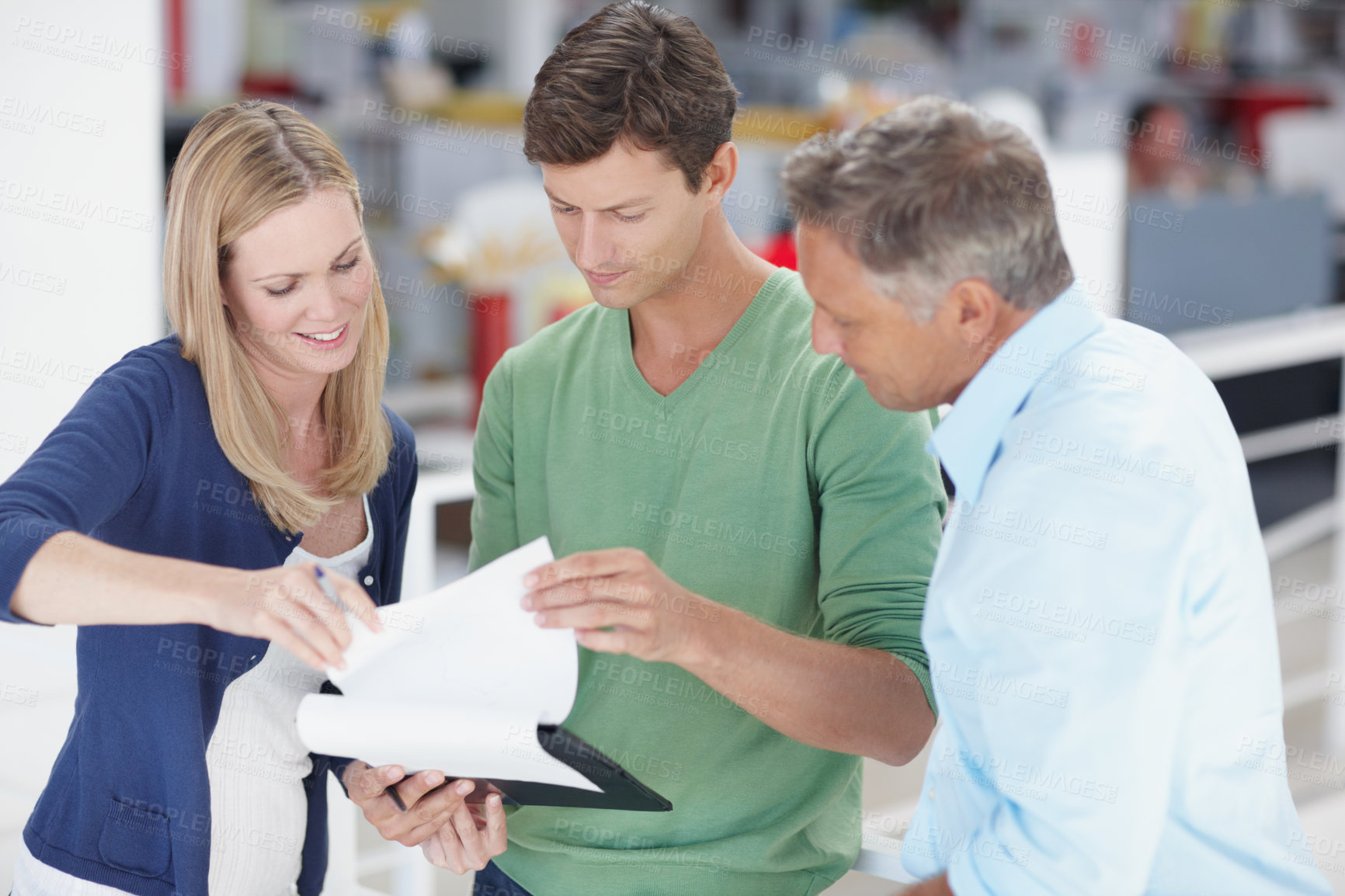 Buy stock photo Three work colleagues discussing something work related