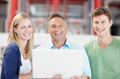 Buy stock photo Portrait of a group of office workers, one holding a laptop