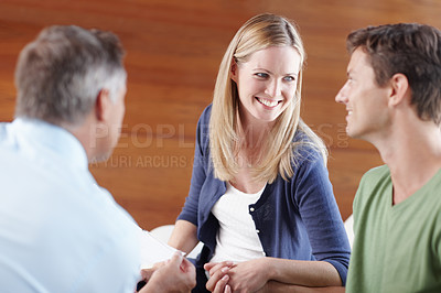 Buy stock photo A young couple getting expert advice from their financial advisor