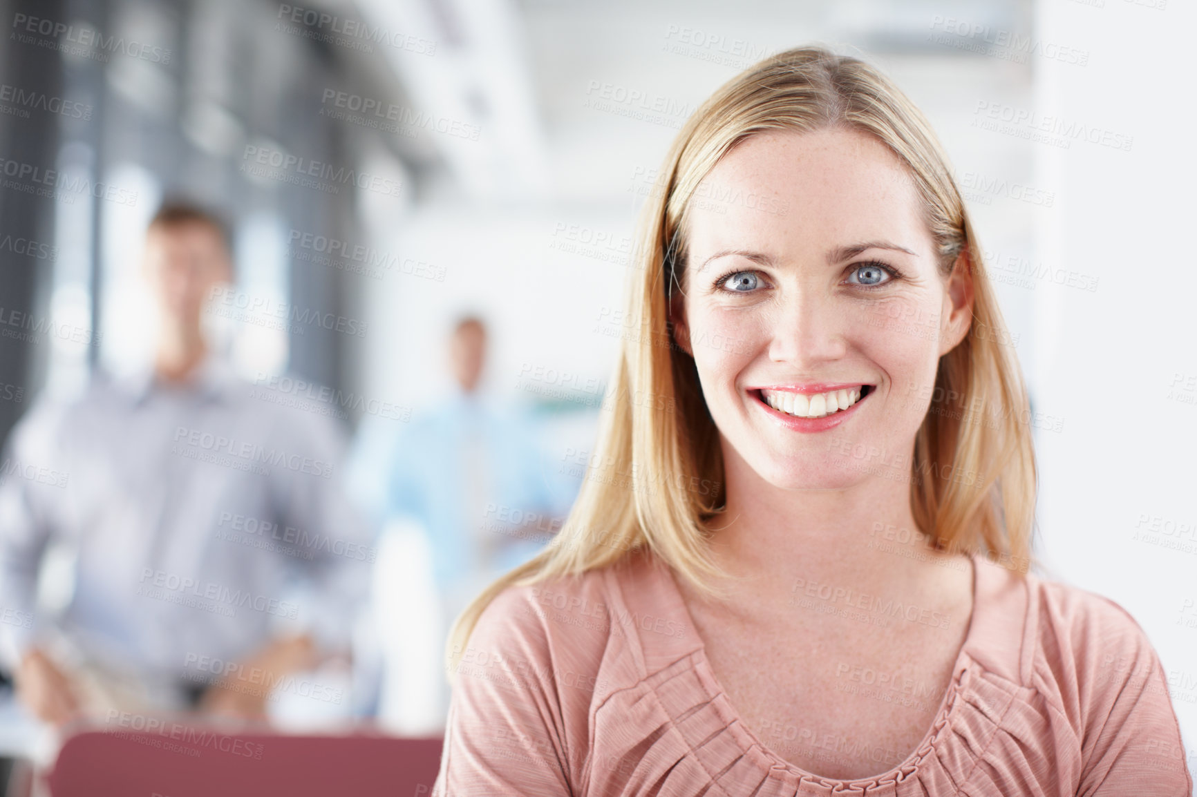 Buy stock photo Portrait of a young designer in the office with colleagues in the background