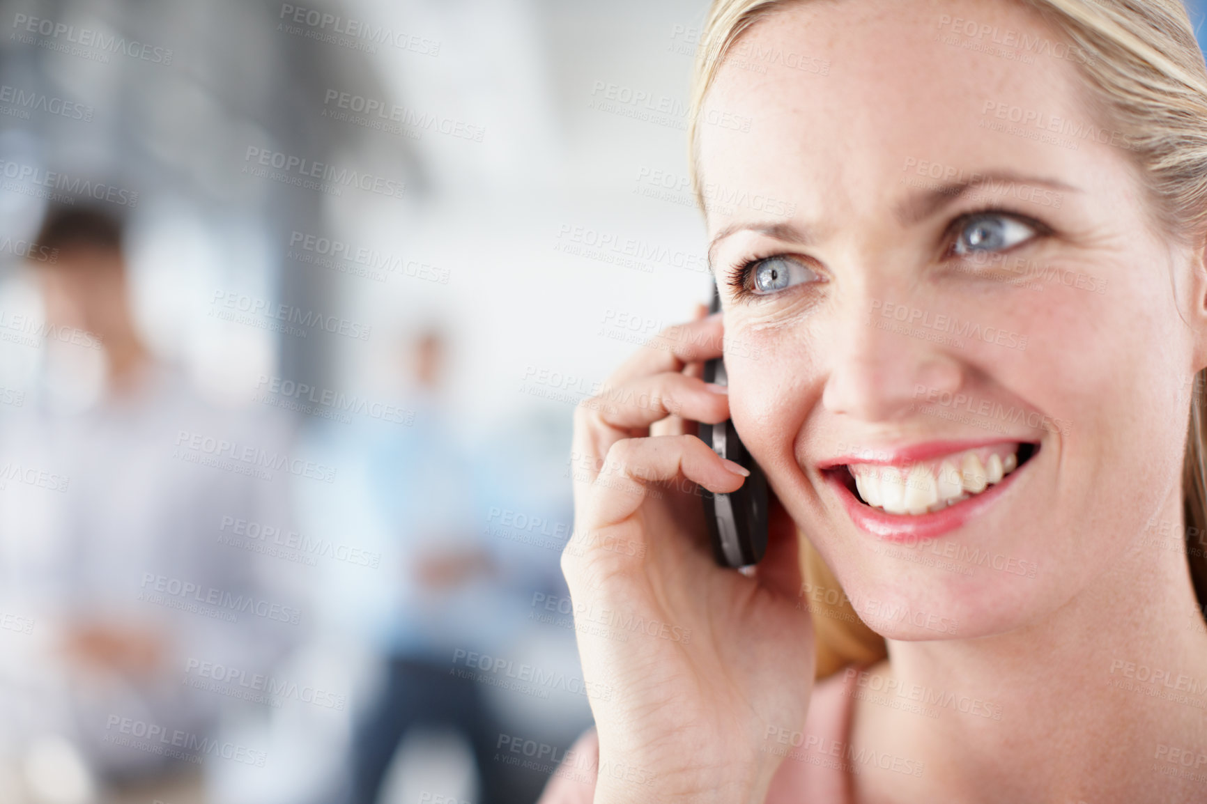 Buy stock photo Closeup of a young professional talking on her smartphone alongside copyspace