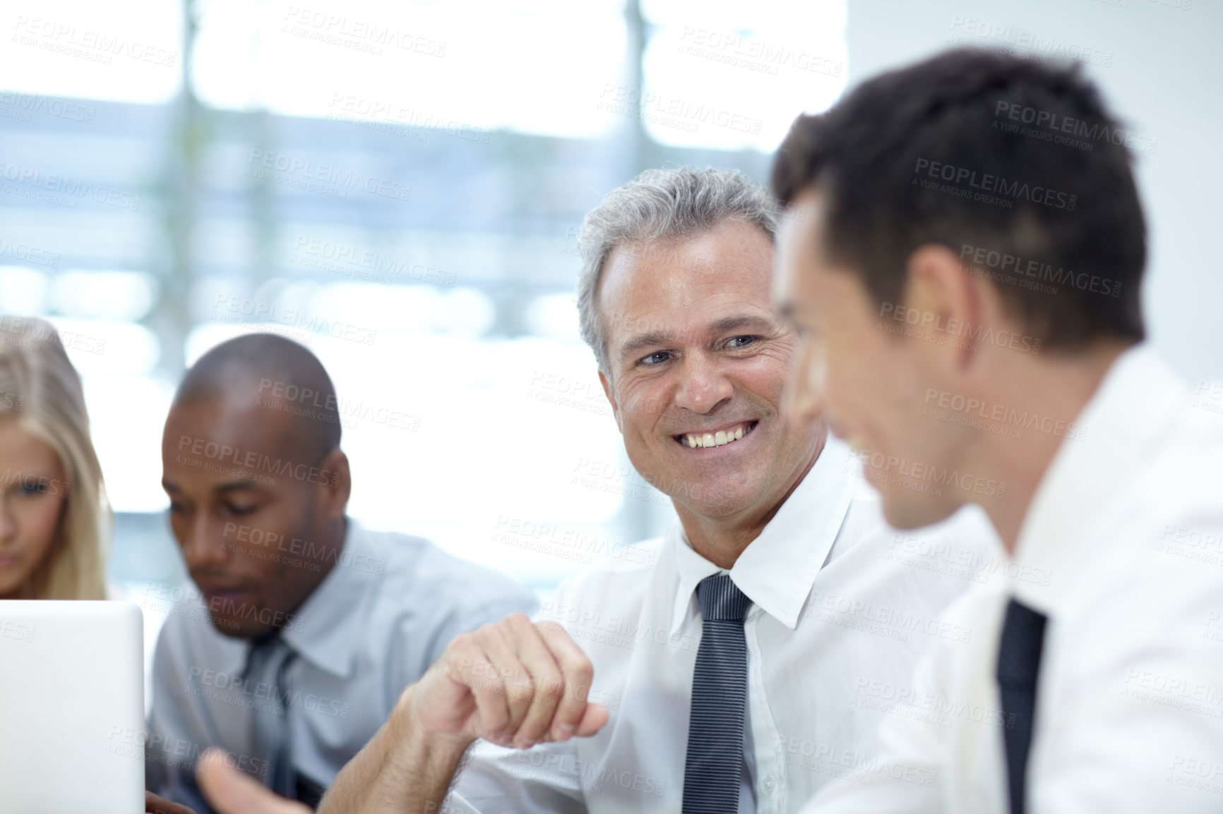 Buy stock photo Shot of a group of business people in a meeting