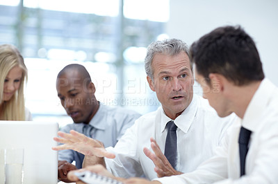 Buy stock photo Shot of a group of business people in a meeting