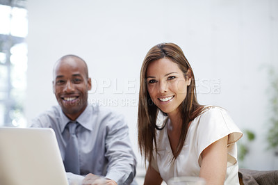 Buy stock photo Portrait of a two young executives working on a laptop together