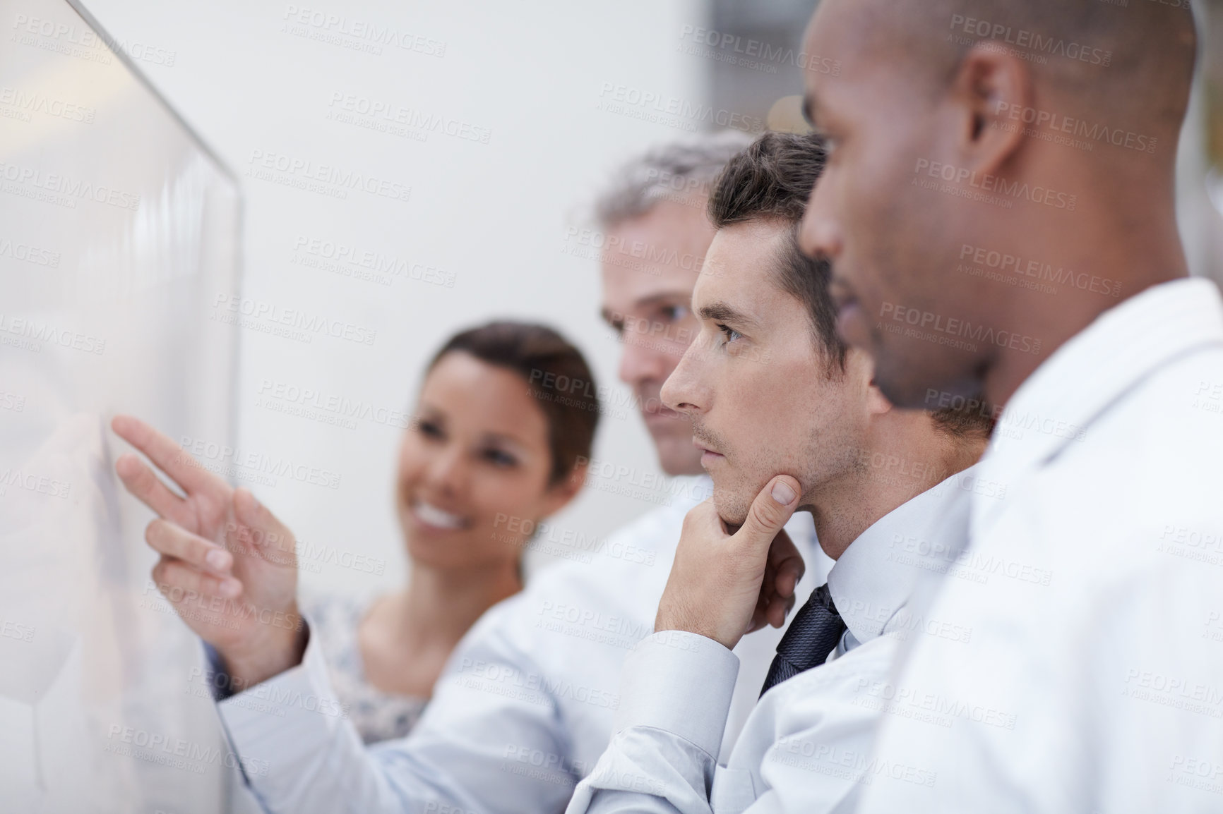Buy stock photo A group of professionals strategize together