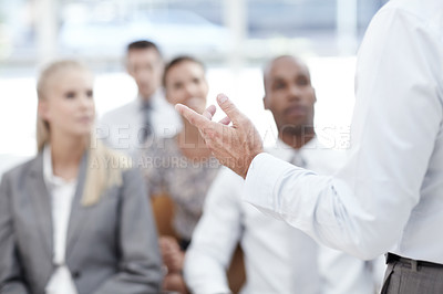 Buy stock photo A businessman gives a presentation to colleagues