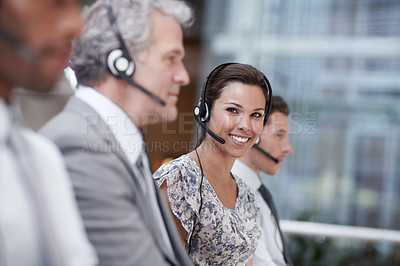 Buy stock photo Portrait of an attractive customer service representative talking into a headset while smiling at the camera