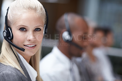 Buy stock photo Portrait of an attractive customer service representative talking into a headset while smiling at the camera