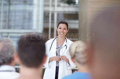 Buy stock photo A doctor delivering a speech in front of some coworkers