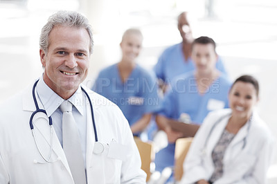 Buy stock photo A doctor standing with colleagues in the background