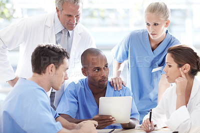Buy stock photo A group of doctors having a discussion